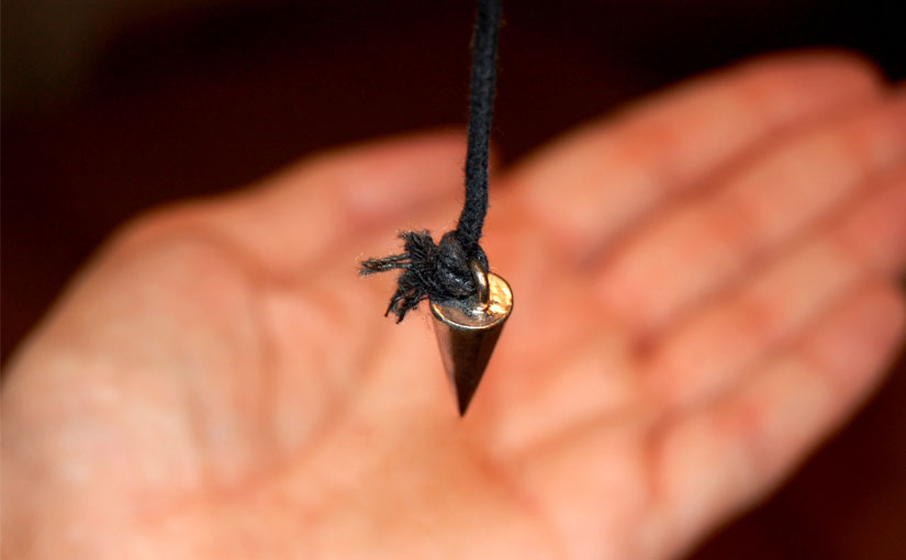 A pendulum over a hand