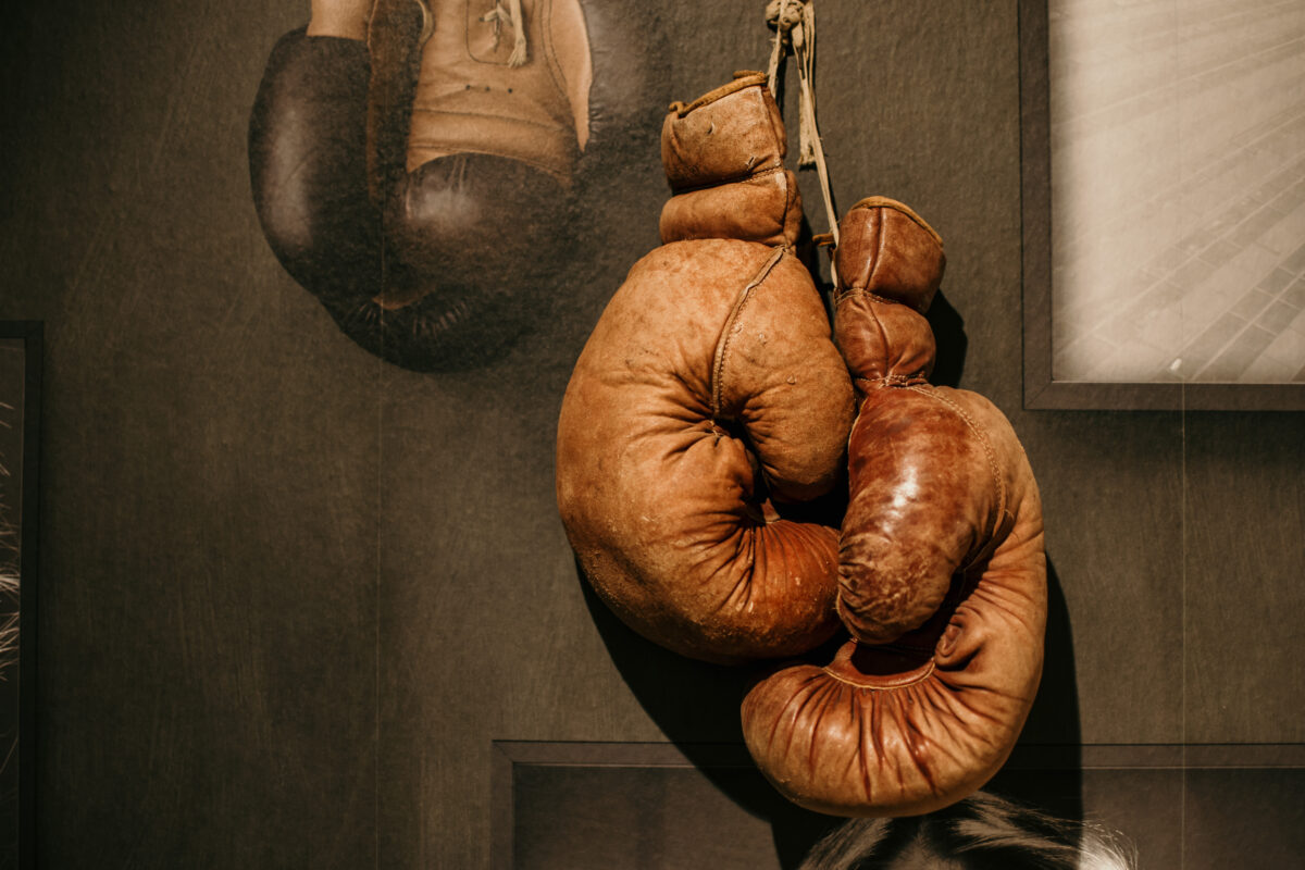 Old boxing gloves hanging on the wall