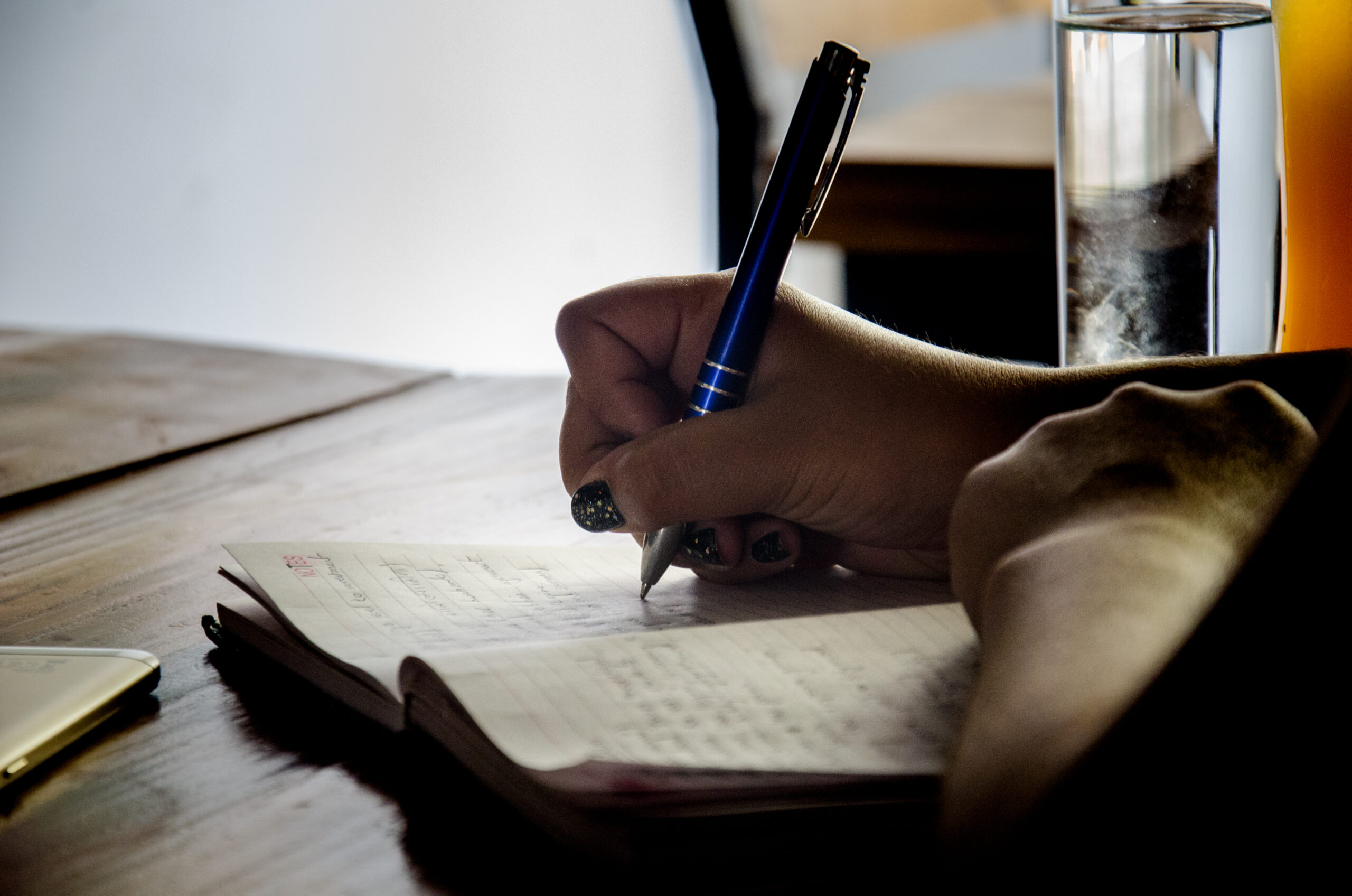 a writer taking notes by hand